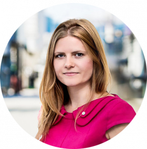 A headshot of Amy Ruddock, VP at Carbon Engineering, outside in front of the company's Direct Air Capture tech