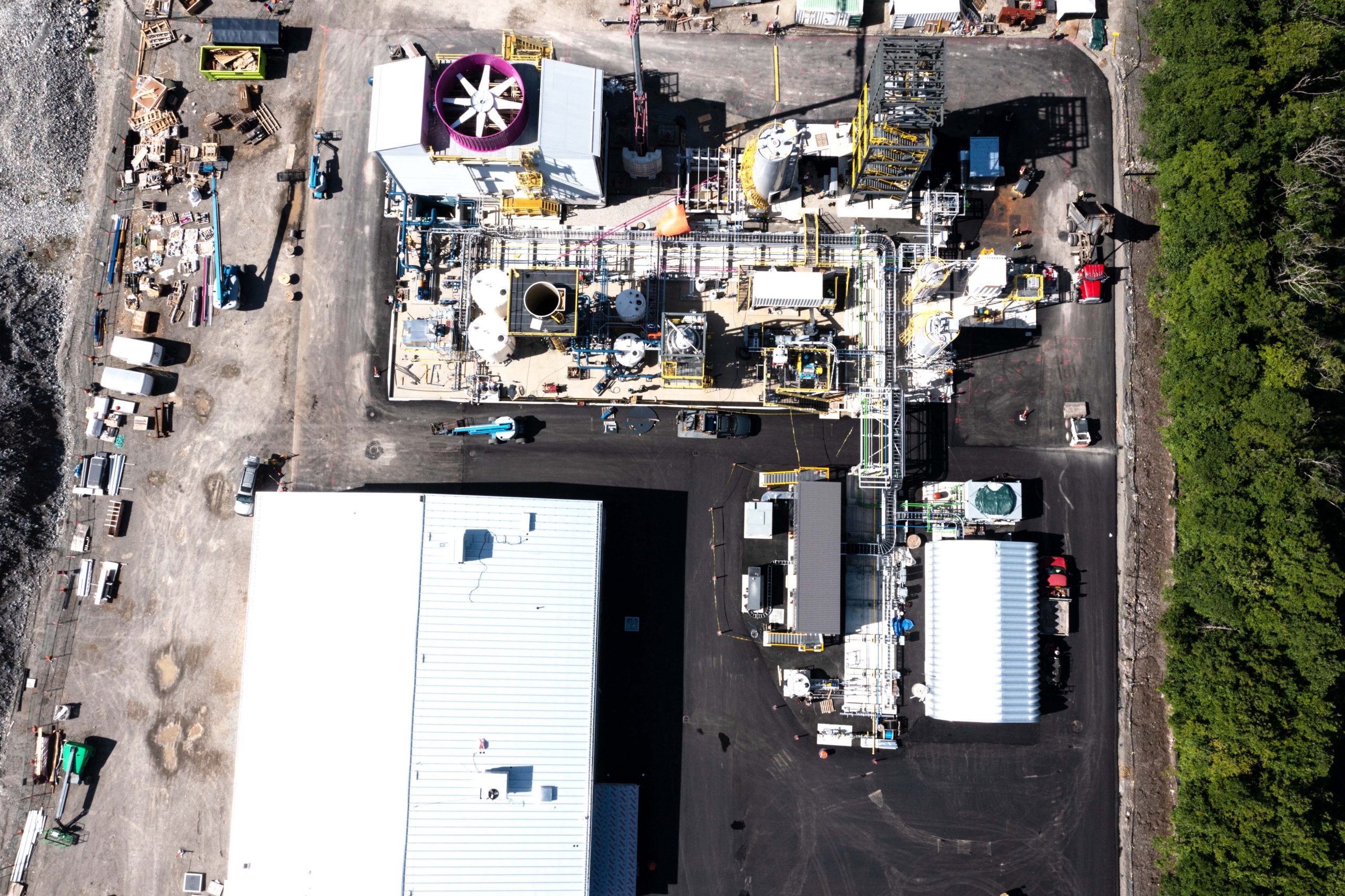 A bird's eye view of Carbon Engineering's Innovation Centre, with an industrial plant on the left and a river on the right